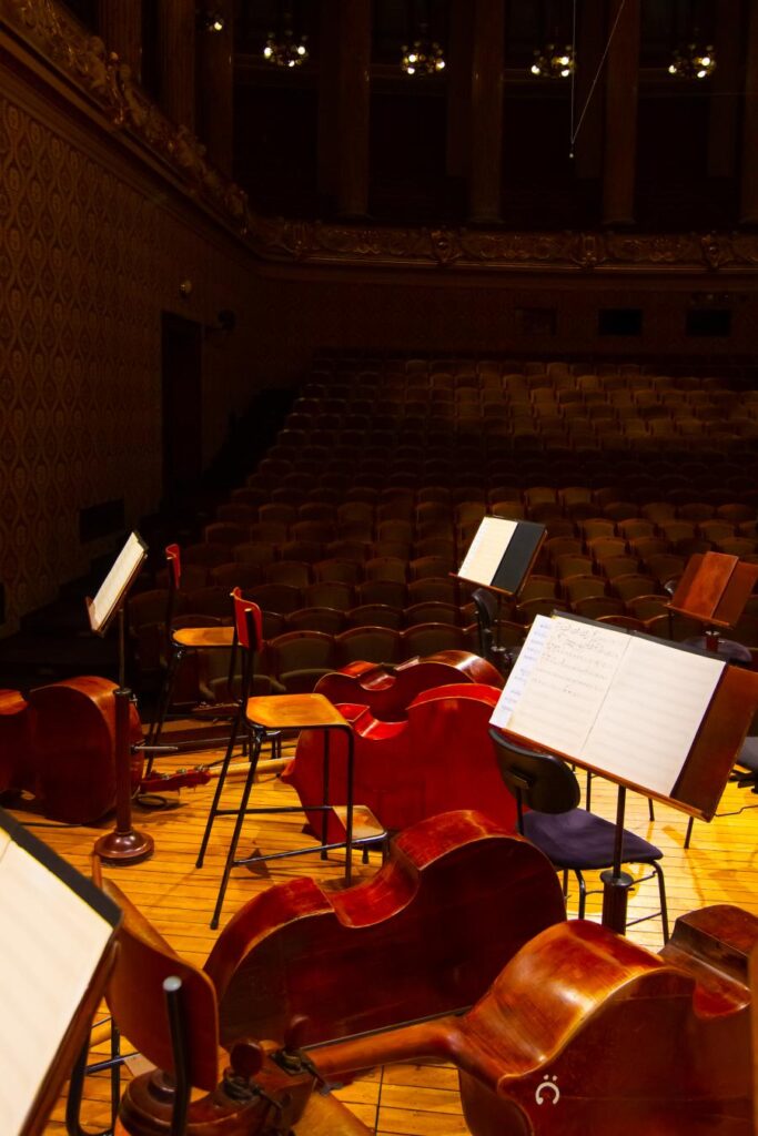 music books and sheets with strings instruments on stage