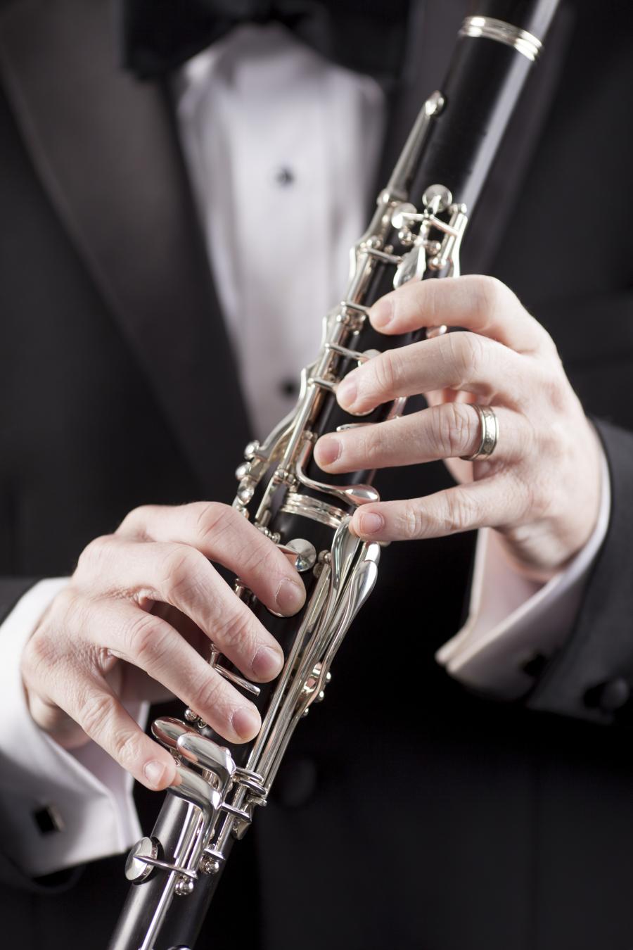 man in tuxedo holding clarinet